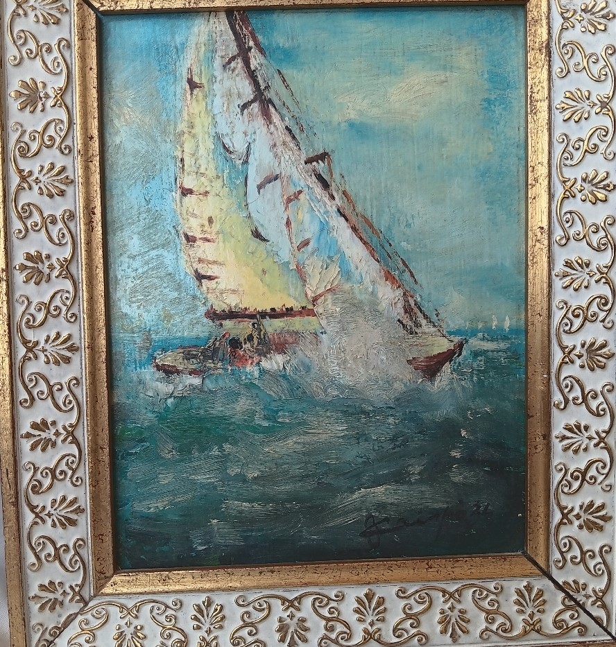 Pintura al óleo de un velero con marco dorado